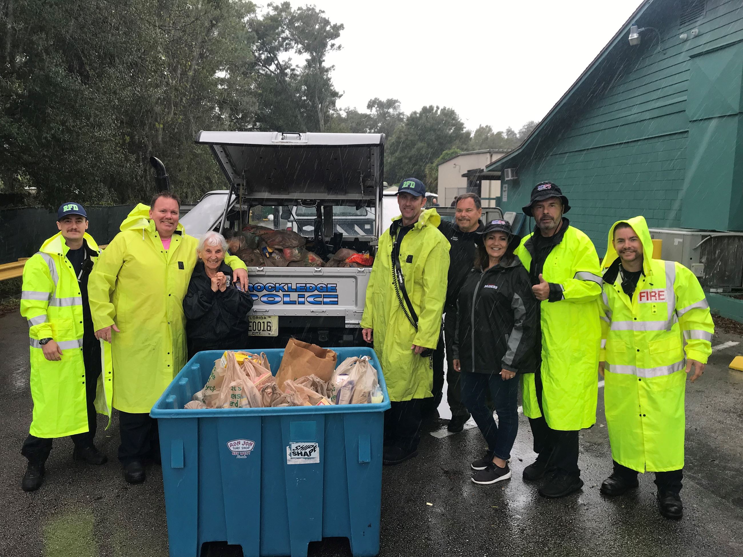 Stuff a Cruiser volunteers showing donations in vehicle and bin