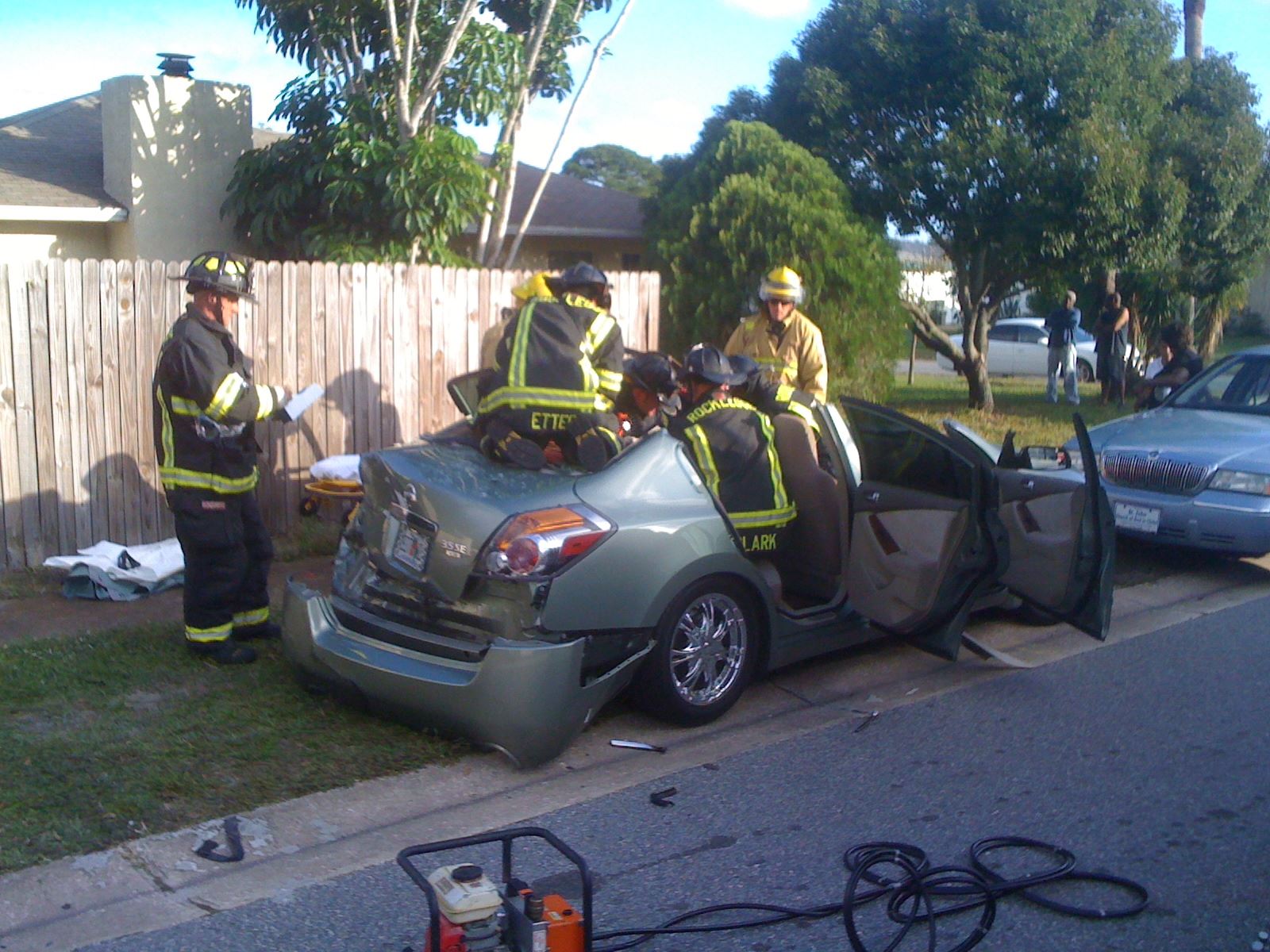 Firefighters in a damaged car